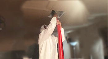 Image of a professional from AJ's Air cleaning a duct